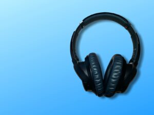black corded headphones on blue background